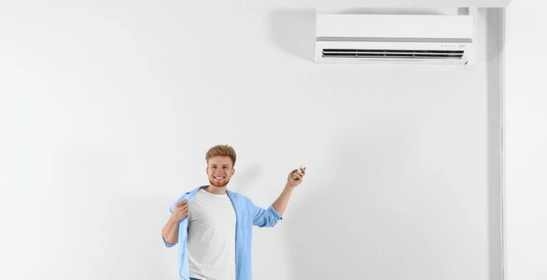 Happy Sarasota Homeowner Using Remote To Control Veteran Air Mini Split AC