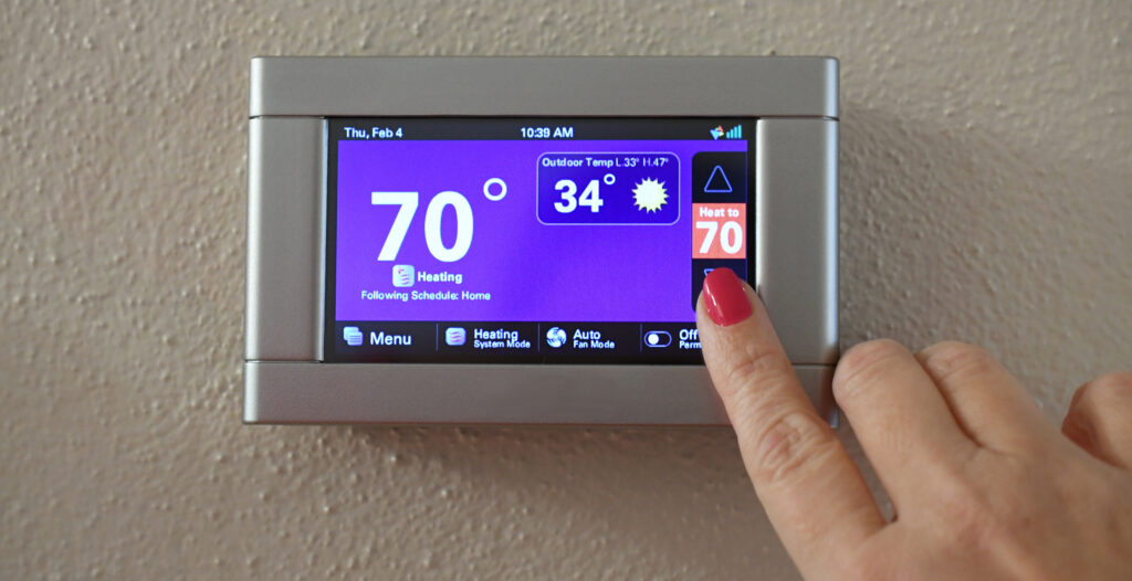 Sarasota Homeowner Adjusting Smart Thermostat Temperature Setting With Veteran Air