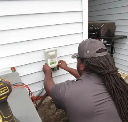 Veteran Air Technician Installing AC Thermostat On Sarasota Home Exterior