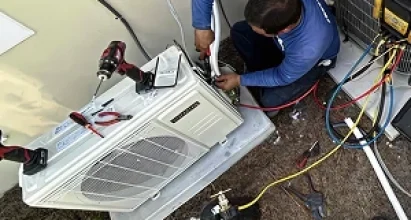 Veteran Air Technician Installing AC Thermostat On Sarasota Home Exterior
