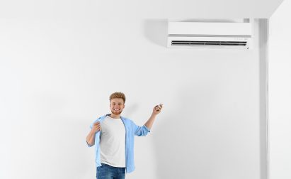 Happy Sarasota Homeowner Using Remote To Control Veteran Air Mini Split AC
