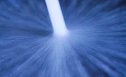 Close-up of a blue abstract pattern with a central white streak, resembling a radial blur effect.