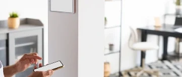 Veteran Air Technician Installing AC Thermostat On Sarasota Home Exterior