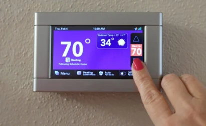 Sarasota Homeowner Adjusting Smart Thermostat Temperature Setting With Veteran Air