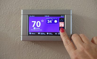 Sarasota Homeowner Adjusting Smart Thermostat Temperature Setting With Veteran Air